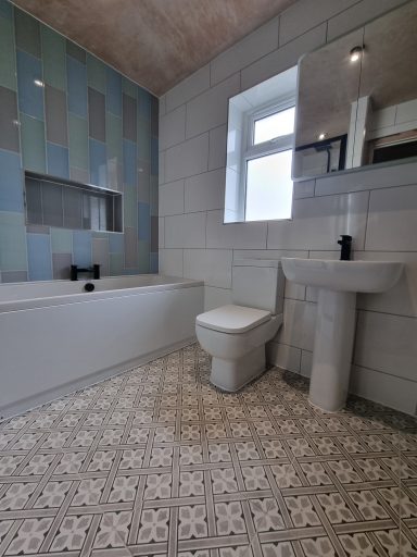 Complete Bathroom suite with stylish patterned floor tiles