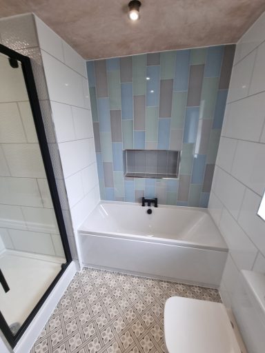 Modern bath with featured tiled wall